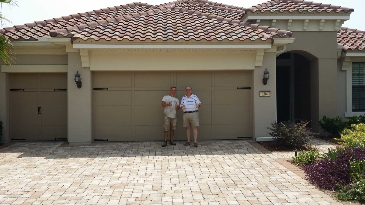 Two men standing in front of a repainted stucco home with a tile roof in Ponte Vedra Beach